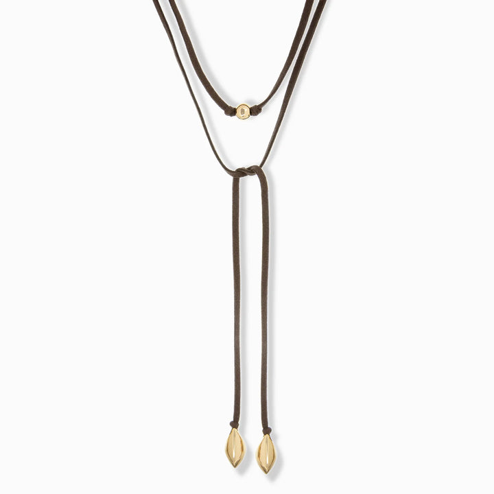 GOLD/BROWN SUEDE CORD NECKLACE WITH BEAD/BEAN CHARMS